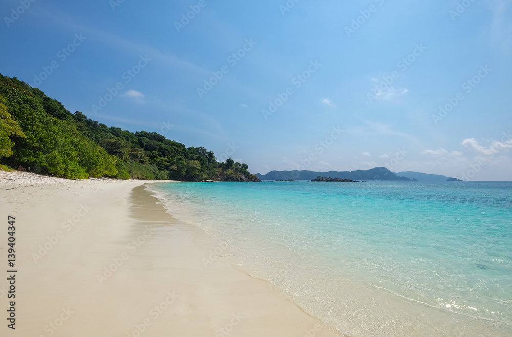 Landscape of sea sun  sand beach under blue sky. Summer holiday relax background with copy space.