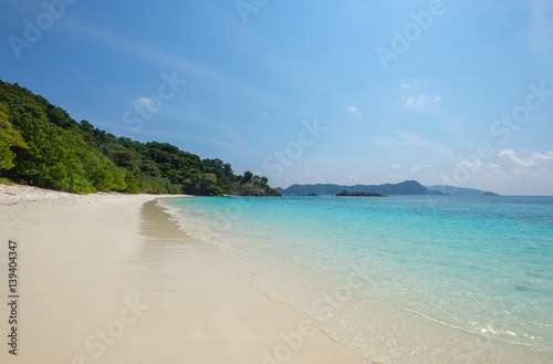 Landscape of sea sun sand beach under blue sky. Summer holiday relax background with copy space.