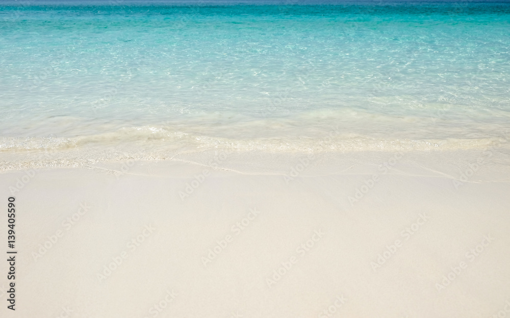 Blue sea wave on sand beach. Summer holiday relax background with copy space.