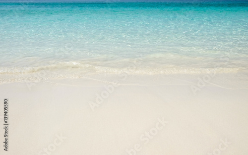 Blue sea wave on sand beach. Summer holiday relax background with copy space.