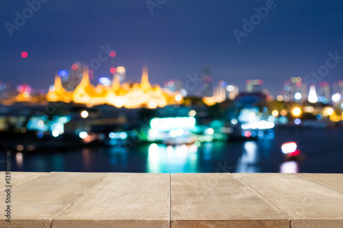 Brown wood floor scene of Bangkok city night light bokeh. Background with copy space for decorate design.