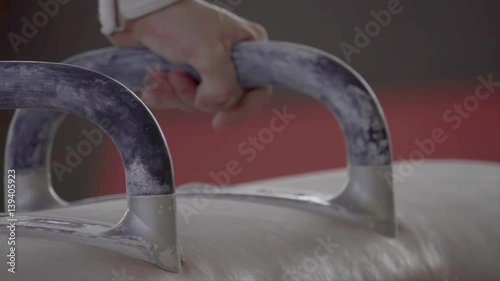 Gymnast doing routine exercises on pommel horse HD slow-motion video. Close-up of athlete hand on gymnastics apparatus.