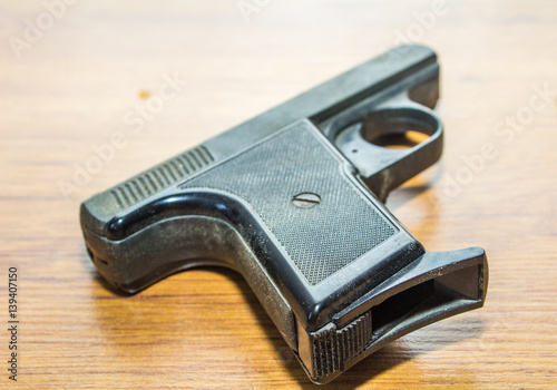 black handgun on wooden background