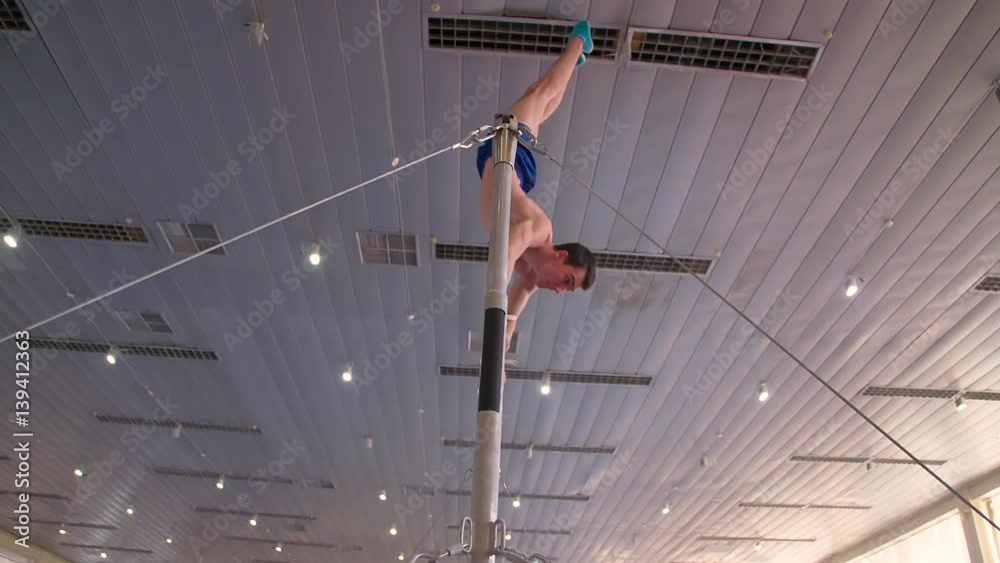 Gymnast exercises on high horizontal bar HD video. Athlete training ...