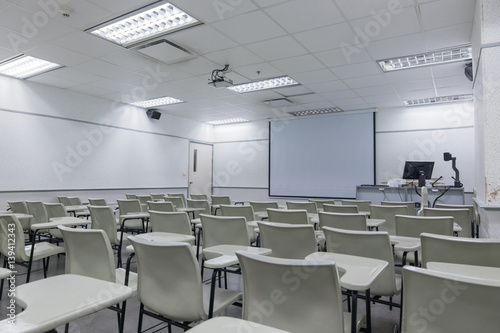 Abstract blur school classroom interior with desk background