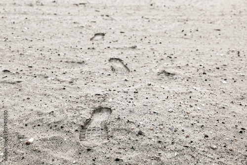 Human footprints in gray sandy ground