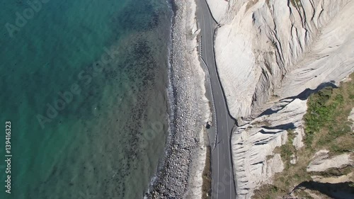 Birds eye view of severe coastal erosion and road in Palliser Bay, New Zealand photo