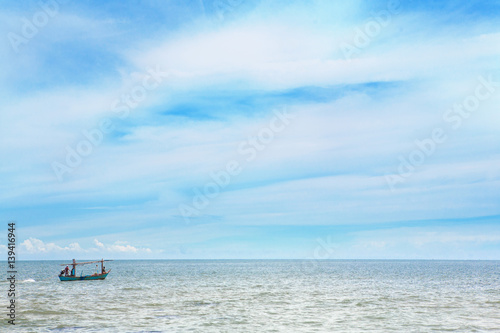 fisherman in small fisher boat on the sea