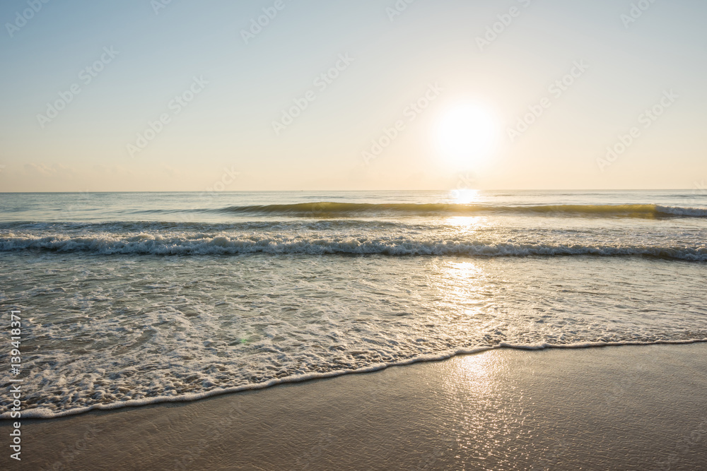 Beautiful sunrise and ripple wave at the tropical beach