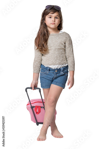 Fotografie Studio shot of cool little girl tourist holding baby pink suitcase