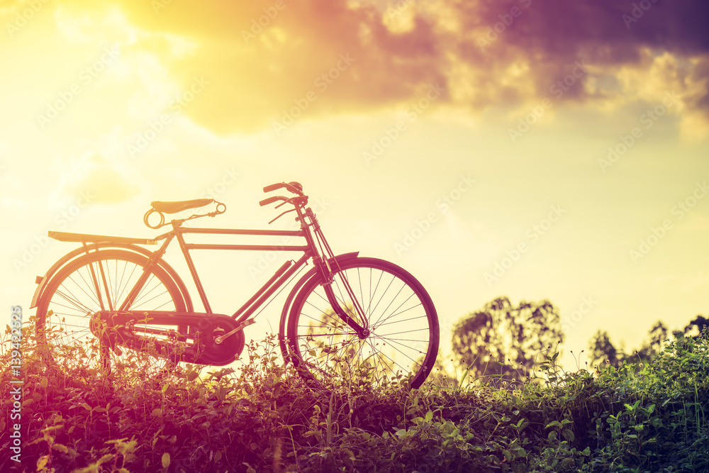 beautiful landscape image with classic Bicycle at sunset
