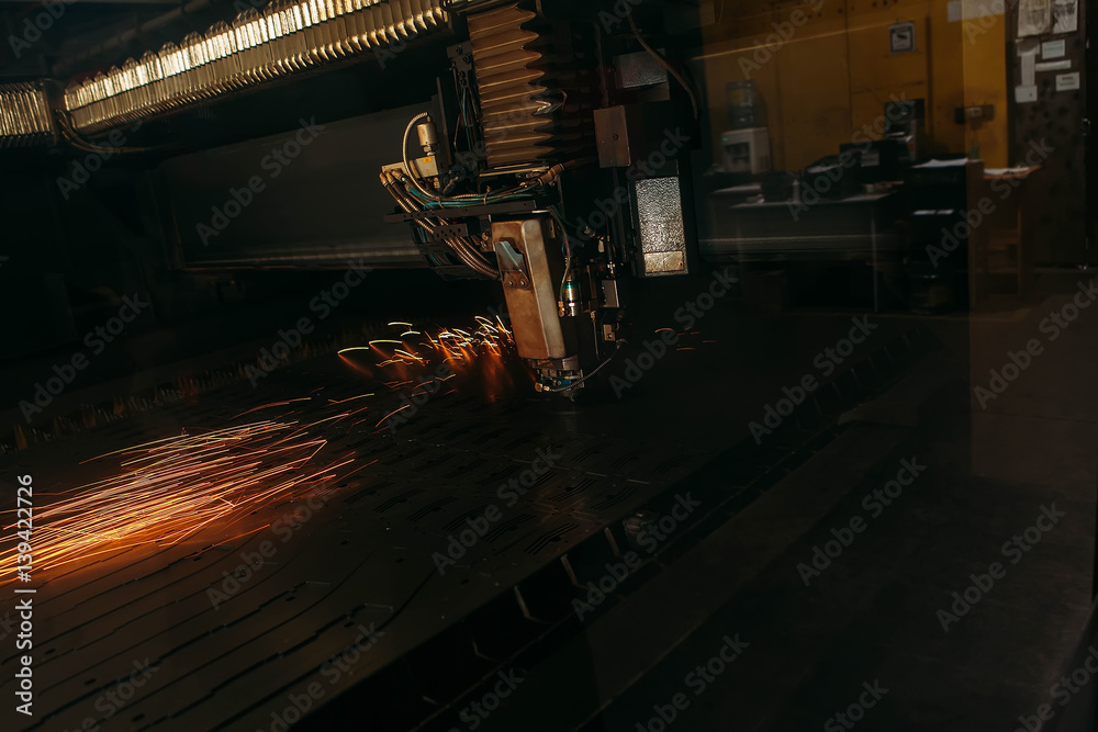 Laser cutting machine cuts the metal with sparks Laser cutting machine cuts the metal with sparks