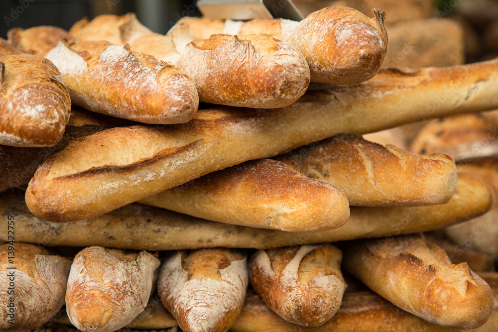 French bread baguettes from bakery. Selective focus. Fresh bred and baguettes background French bread baguettes from bakery. Selective focus. Fresh bred and baguettes background