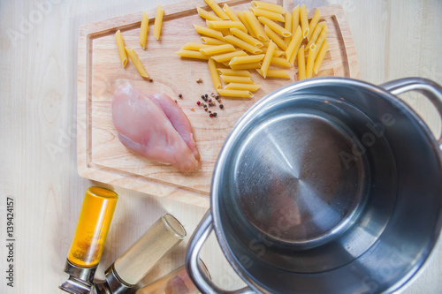 Ingredients cooking chicken fillet pasta wooden background top view