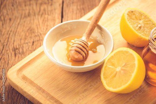 Lemon slice with honey on wood table