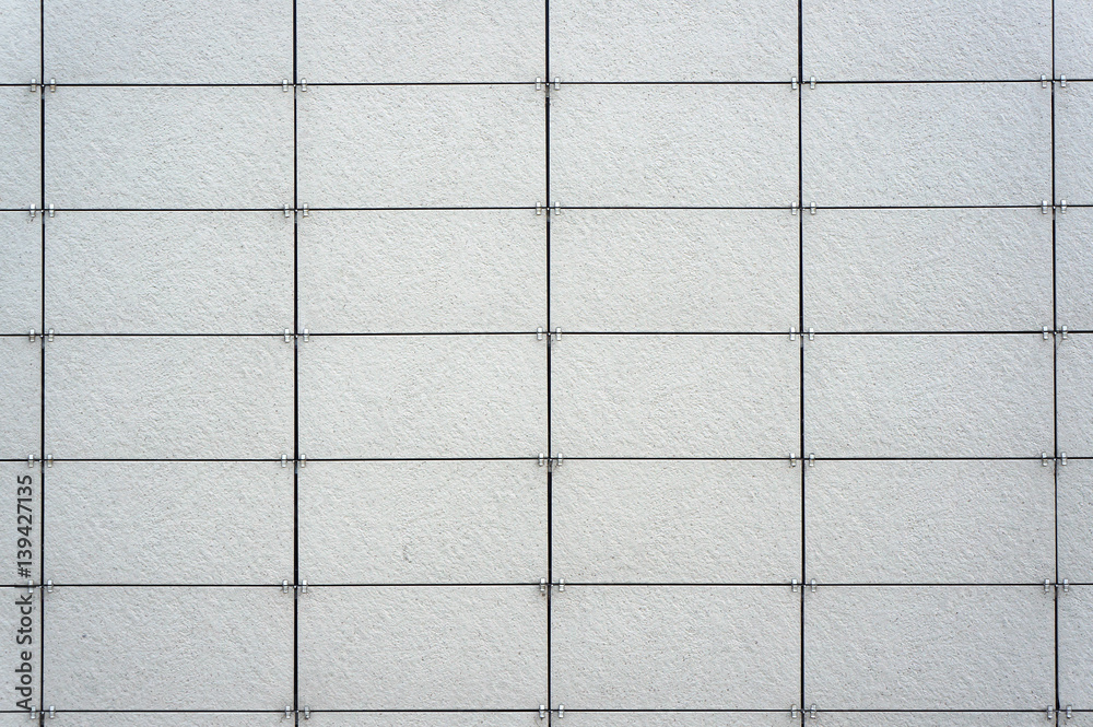 Wall coated with facing panels. Architectural background. Wall coated with facing panels. Architectural background.