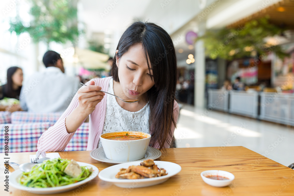 Woman enjoy her meal in restaurant Woman enjoy her meal in restaurant