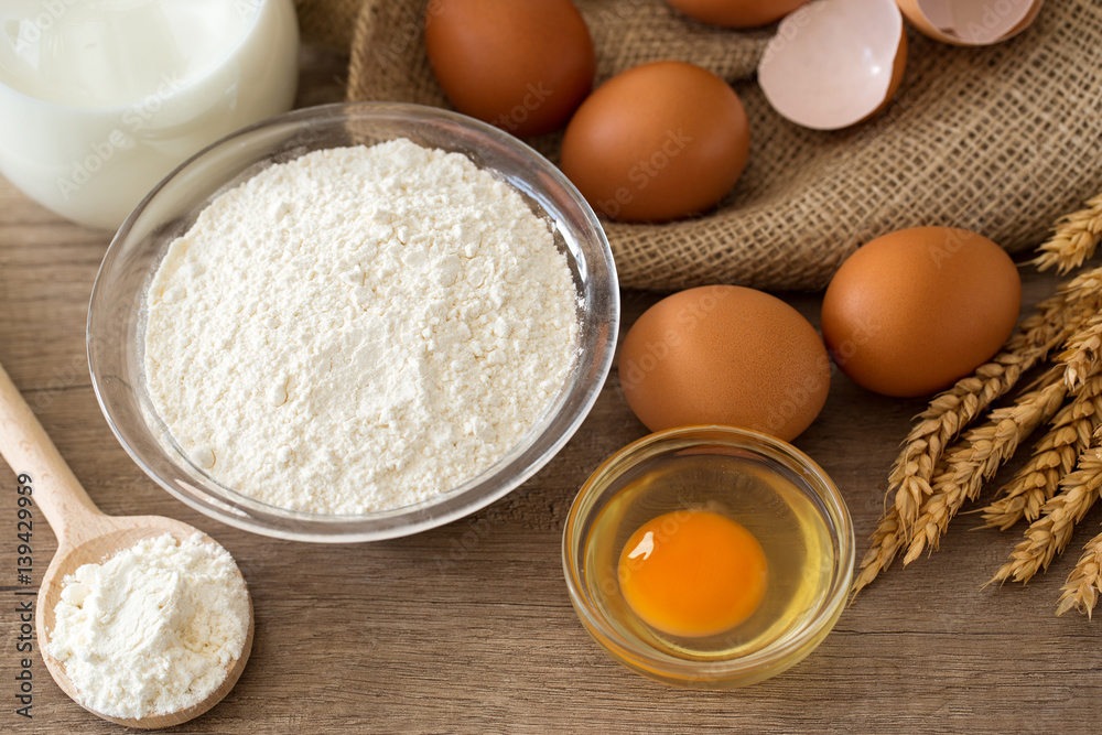 Eggs, flour and milk on wooden background. Eggs, flour and milk on wooden background.