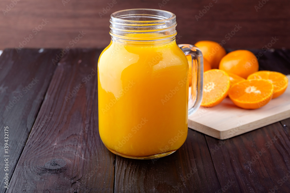 Orange juice on wooden background Orange juice on wooden background