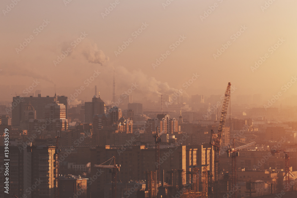 Close-up shooting from high point of morning metropolitan city: residential buildings and districts, churches, office business, smoke from chimneys, cranes, windows, hazy horizon, Moscow, Russia Close-up shooting from high point of morning metropolitan city: residential buildings and districts, churches, office business, smoke from chimneys, cranes, windows, hazy horizon, Moscow, Russia