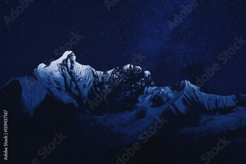 Mountain range in the night with stardust background