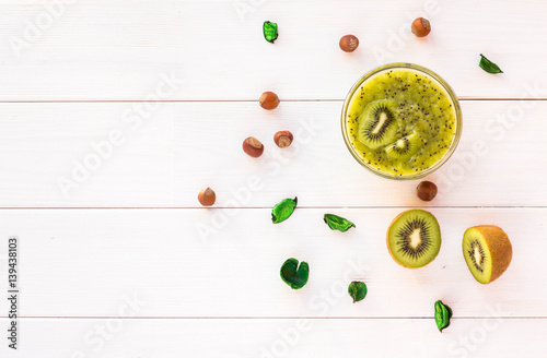 kiwi and nuts on white wooden background. Flat lay.