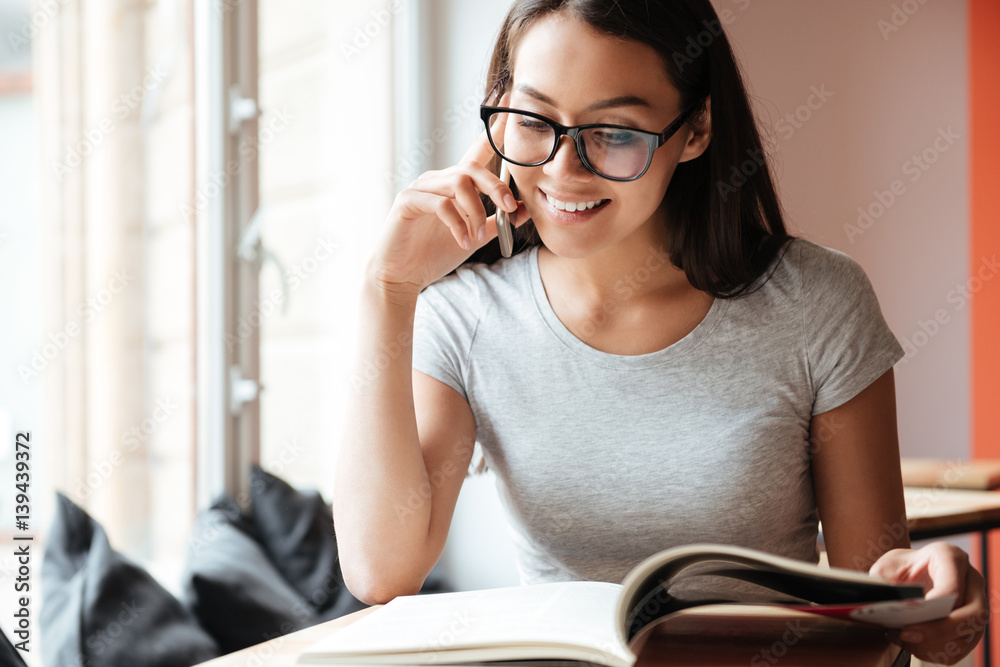 Caucasian pretty woman indoors talking by mobile phone