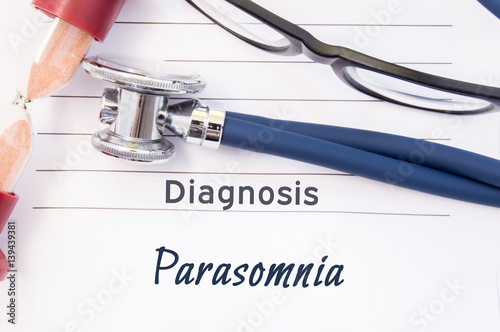 Diagnosis Parasomnia. Psychiatric diagnosis Parasomnia is written on paper, on which lay stethoscope and hourglass for measuring time to research. Concept photo for psychiatry or psychology photo