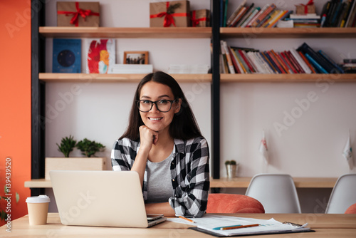 Pretty young caucasian woman using laptop computer.