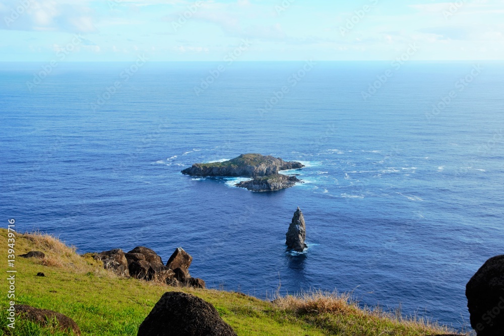 Long shot of the Orongo village between the Rano Kau crater and the Pacific ocean close to Hanga Roa the capital of Easter Island, Rapa Nui, Chile, South America Long shot of the Orongo village between the Rano Kau crater and the Pacific ocean close to Hanga Roa the capital of Easter Island, Rapa Nui, Chile, South America