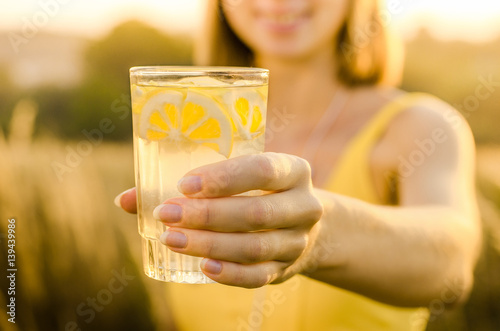 Diet. Healthy eating .Woman hand holding lemonade drink  on the background blurred nature outdoor. Fresh detox vegetable juice. Healthy lifestyle, vegetarian food. Nutrition Concept.