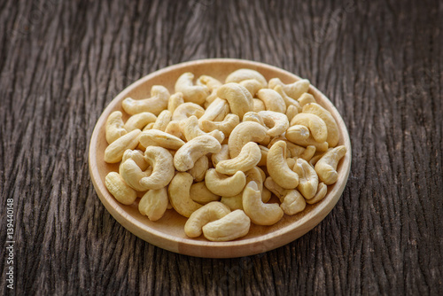 close up of cashew nut in wood dish