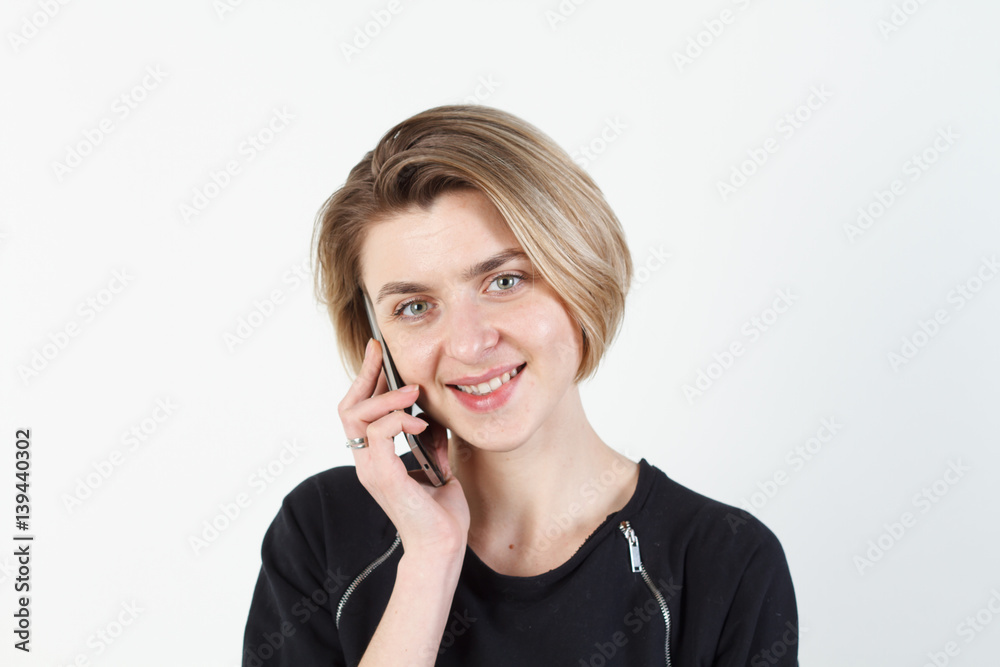 Businesswoman talking on the phone very emotional. She smile, anger, aggression, misunderstood, outrage. On a white background. Happy smiling successful businesswoman with cell phone, isolated on Businesswoman talking on the phone very emotional. She smile, anger, aggression, misunderstood, outrage. On a white background. Happy smiling successful businesswoman with cell phone, isolated on