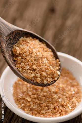 Raw Organic Cane Sugar in a wooden spoon © Looker_Studio