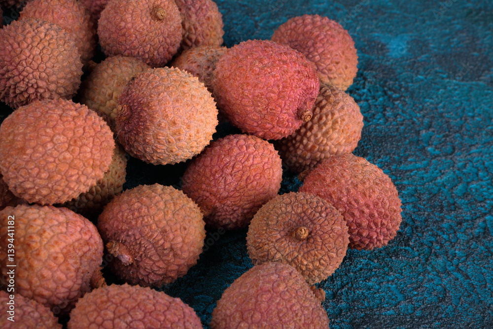 Lychee on a blue cement background Lychee on a blue cement background