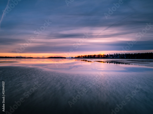 Sunset over partly frozen lake in Sweden