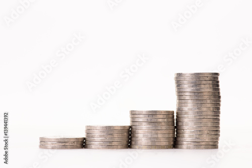 money coins arranged as a graph on white background