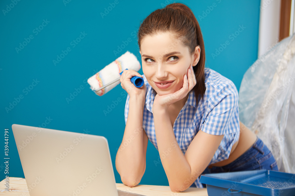 Brunette girl having a break while renovating home Brunette girl having a break while renovating home