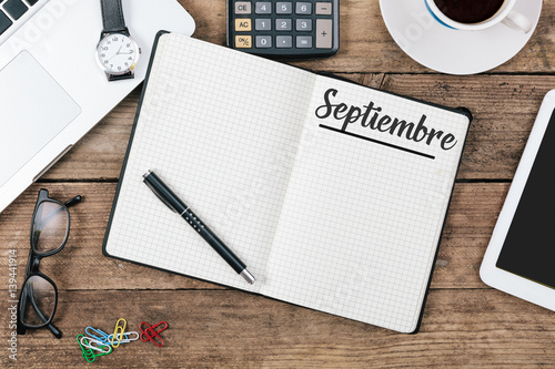 Septiembre (Spanish September) month name on paper note pad at office desk