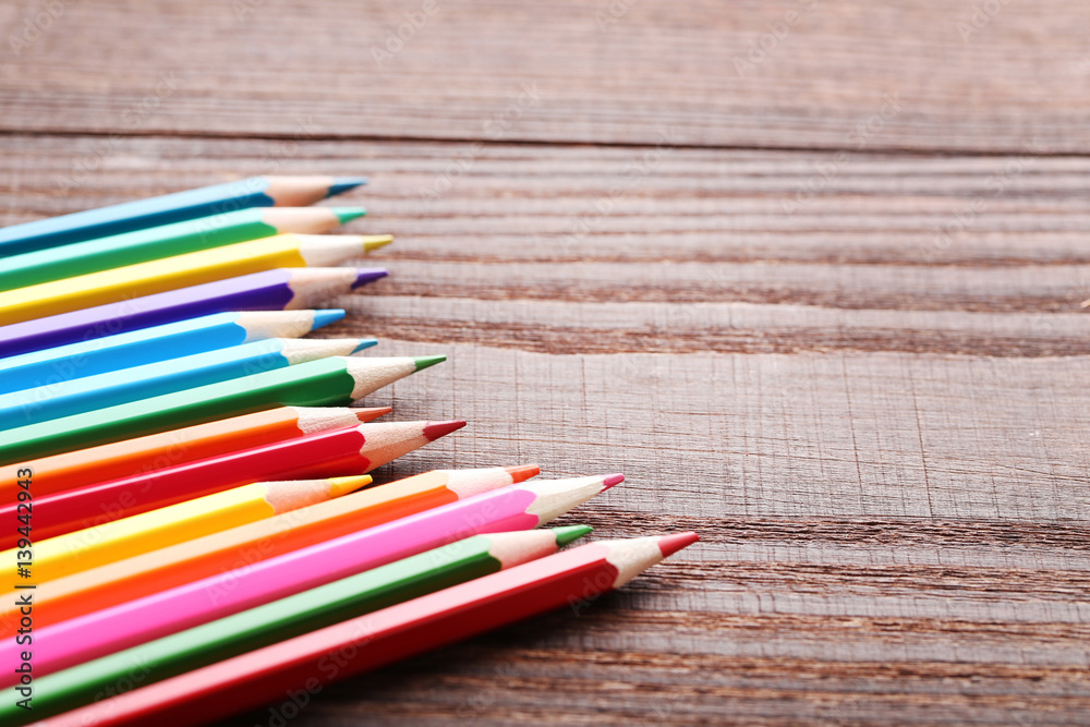 Drawing colourful pencils on brown wooden table Drawing colourful pencils on brown wooden table