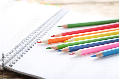 Drawing colourful pencils with blank notebook