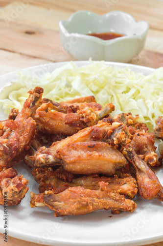 Chicken wings in plate with and cabbage alley.