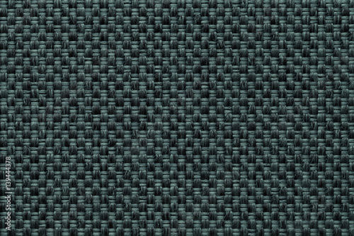 Dark green textile background with checkered pattern, closeup. Structure of the fabric macro.