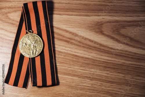 Fototapeta Naklejka Na Ścianę i Meble -  Medals of the Patriotic War in St. George's Ribbon on a wood background. 9 may