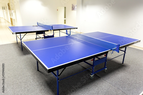 Two blue ping pong tables in the room