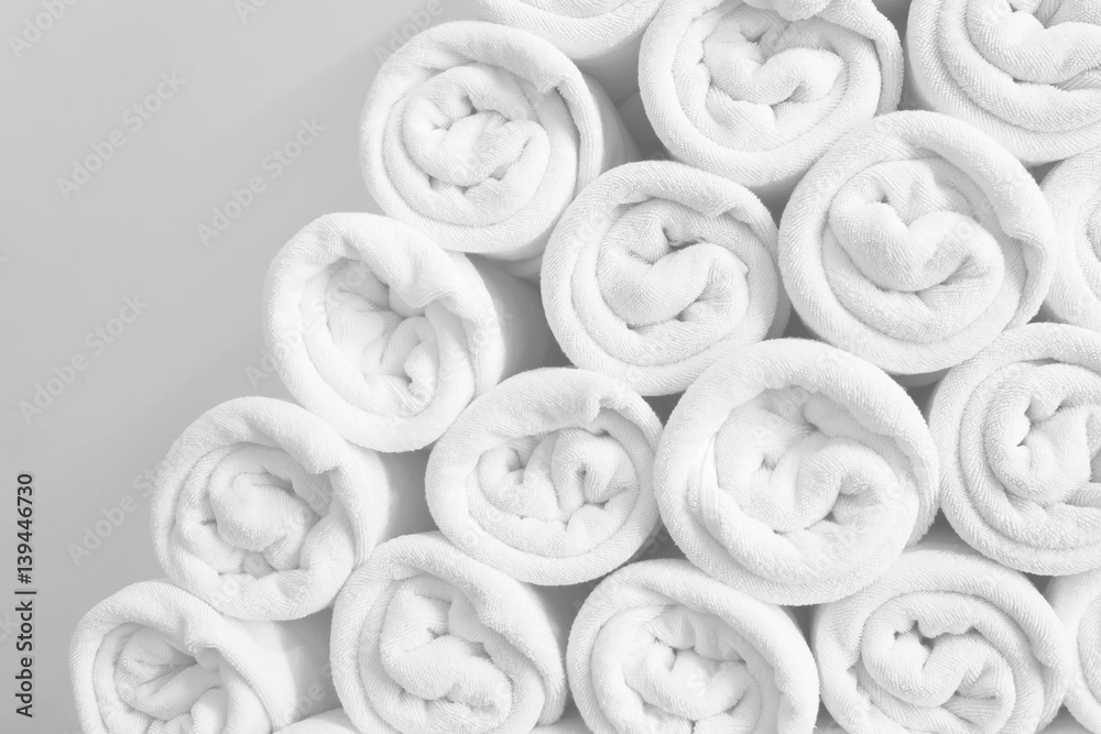 Rolled up white spa towels or bath towels keep in store room . Stock Photo