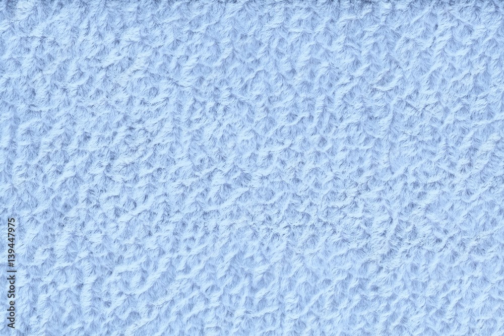 Light blue fluffy background of soft, fleecy cloth. Texture of textile closeup Light blue fluffy background of soft, fleecy cloth. Texture of textile closeup
