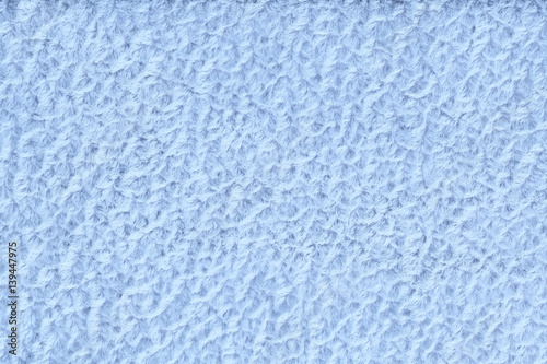 Light blue fluffy background of soft, fleecy cloth. Texture of textile closeup