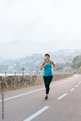 Young woman in sport on the sea coast