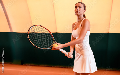 Sportswoman at the tennis court with racquet. © nazarovsergey
